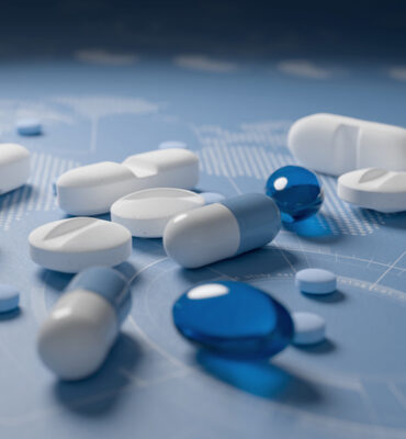 Heap of medications on blue background